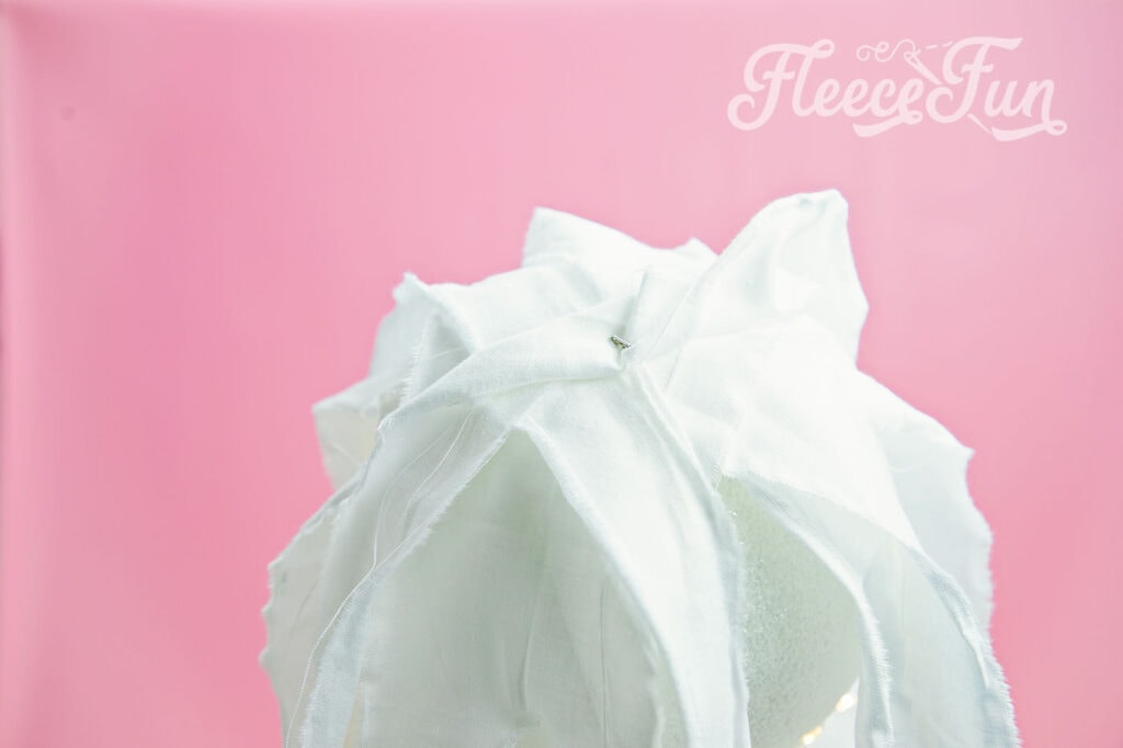 Creating the ghost’s shape by covering the tomato cage with fleecefun’s free template and tutorial