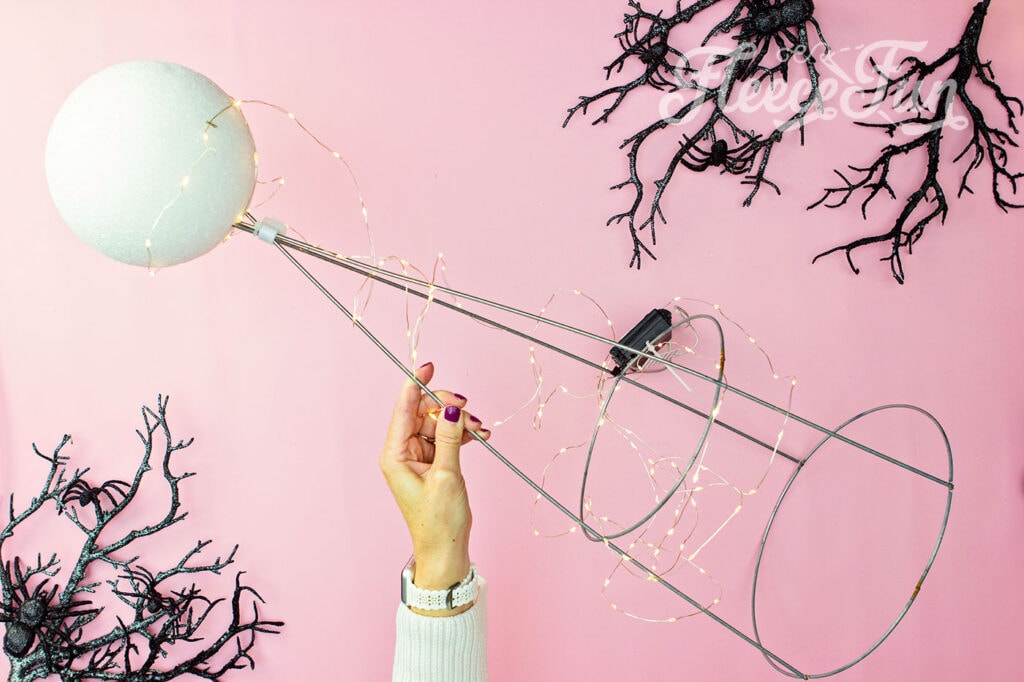 use t pins to anchor the lights to the styro foam ball