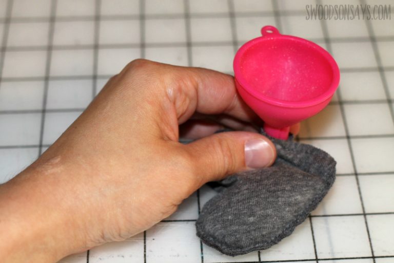 Filling heart-shaped hand warmer inserts with rice following fleecefun tutorial