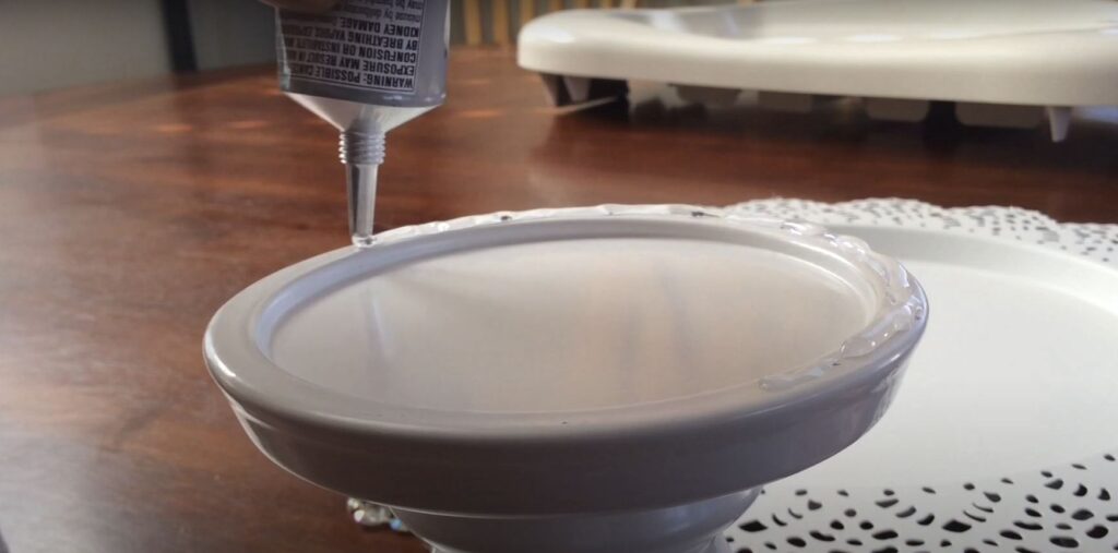 Applying glue candlestick to tray. This beaded cake stand looks like it came from a high-end wedding catalog—but it’s DIY, affordable, and seriously fun to make. With just a few supplies, you can create elegant beaded stands that add sparkle to any table. Perfect for weddings, birthdays, or just showing off your baking wins. Your dessert deserves the spotlight—let's make it shine!