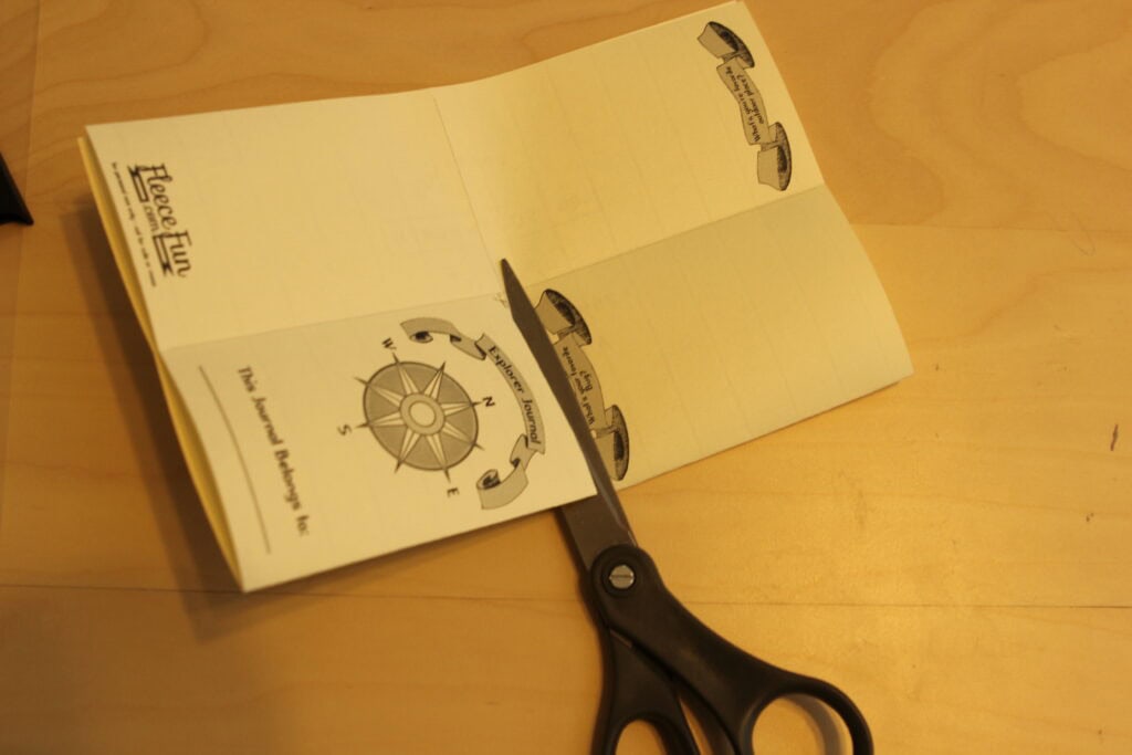cutting the center opening. a Free Printable Kids Explorer Journal, perfect for parties, summer play time, and kid explorers, made with free template and step by step tutorial, from fleece fun