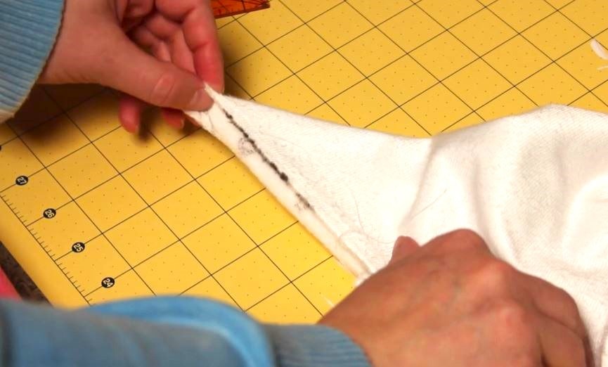 Folding the blanket on the corners.