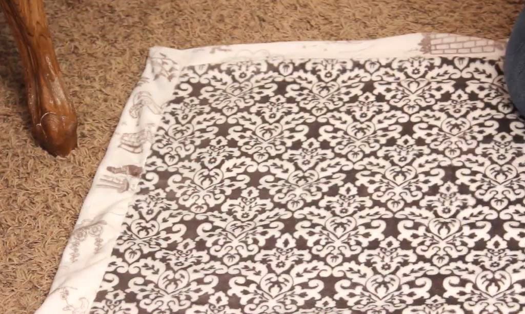 Laying the blanket flat.
