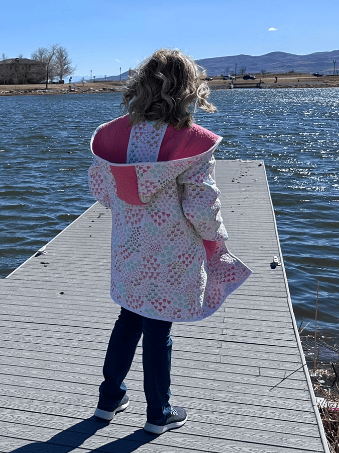Quilted coat worn or styled outdoors, showing the fabric texture and relaxed fit